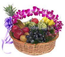 Basket of mixed fruits and purple orchids with a ribbon bow. Gift to your grand parents.