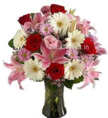 Valentine Special Product specially from top Florist. 10 Pink Carnation, 10 Red Roses, 15 Pink and White Gerbras and 5 PC Pink Lilies in a Clear Simple Glass Vase 