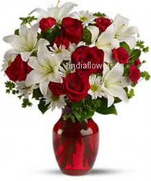 Beautiful arrangement of white lilies and Red roses in a clear glass vase. 20 Roses and 6 PC Asiatic White Lilies