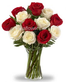 Glass vase with 12 Red and White Roses nicely decorated with fillers 