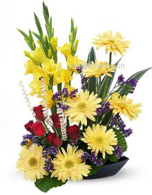 Arrangement of Yellow Gerbera Gladioli and Roses nicely decorated with fillers and greens
